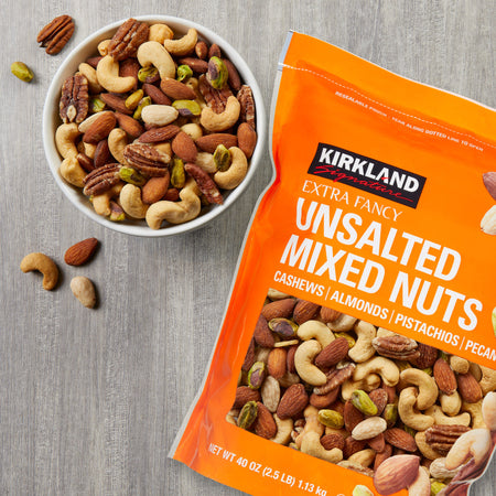 Kirkland Signature unsalted mixed nuts package and bowl of nuts on a gray surface