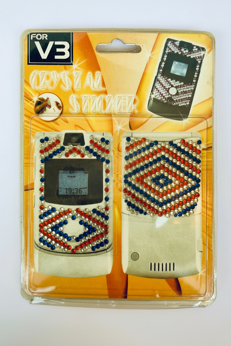 Packaged crystal-studded V3 phone case with decorative patterns on a white background