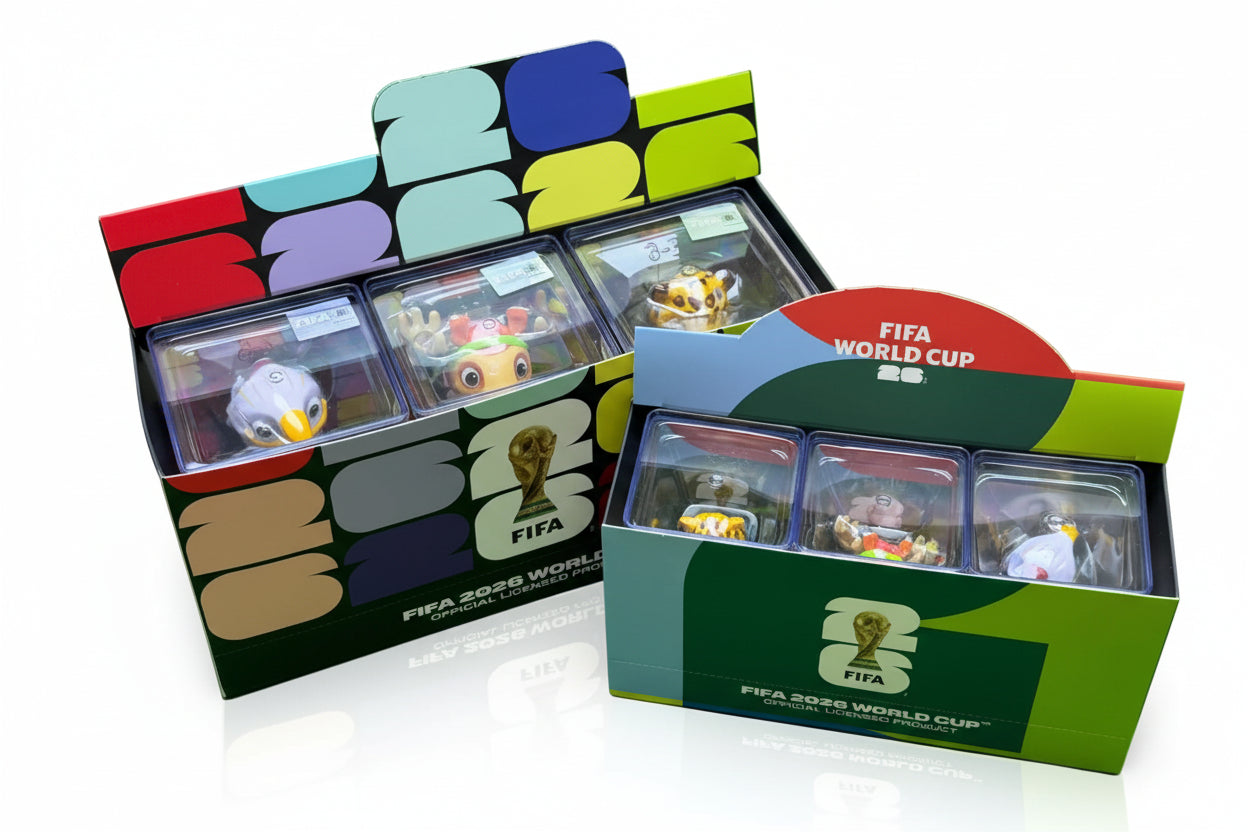 FIFA World Cup trading card boxes with cards inside on a green background
