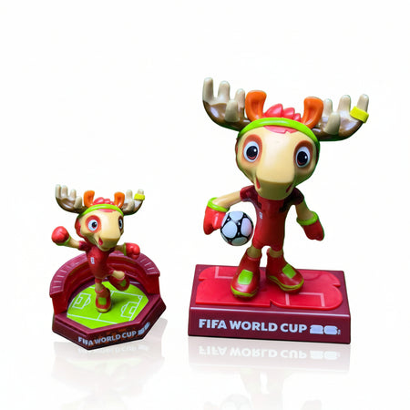Two moose-shaped figurines with FIFA World Cup branding on a green background