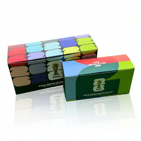 Two FIFA World Cup 2022 boxes on a green surface