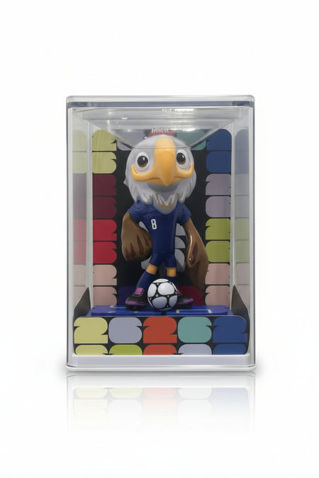 Figurine of an eagle holding a soccer ball in a clear packaging box.