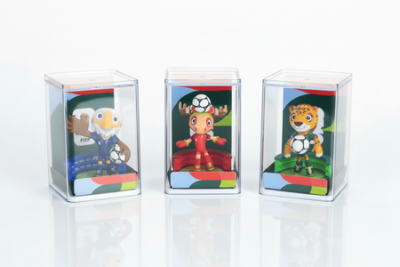 Three toy figures in clear display cases on a white background