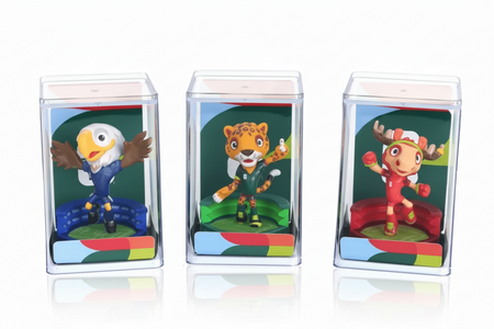 Three colorful animal figurines in clear display cases on a white background