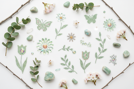 Light green multi-color rhinestone phone stickers flat lay with spring flowers and natural accessories