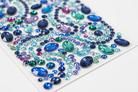 Close-up of blue multi-color rhinestone bling stickers showing individual sparkling gems