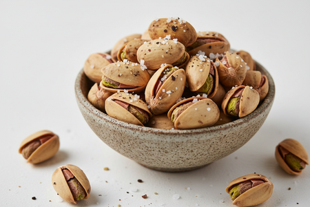 Close-up of roasted pistachios in shell with salt and pepper seasoning