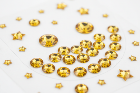 Close-up of golden smile rhinestone bling stickers showing individual sparkling gems
